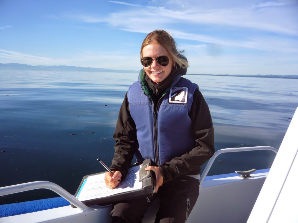 Student Alex Ulmke collecting data on whale from a boat in the Puget Sound