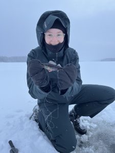 Iida Jaervinen kneels in the snow