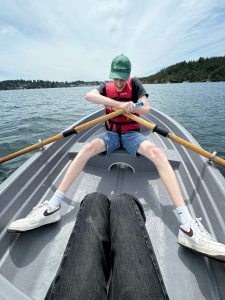 Braden Hisaw holds the paddles on a rowing boat