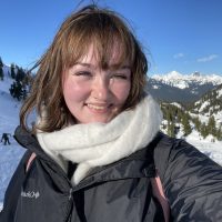 Lauren Grady takes a selfie on a snowy mountain.