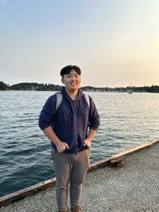 Eddie Yau stands on a dock