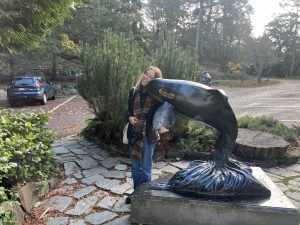Kylie West poses with a sculpture of an orca