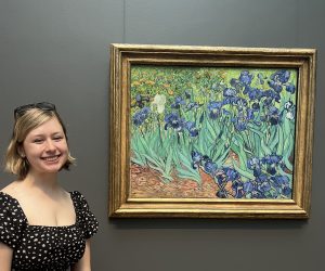 Iris Haley stands in front of a painting