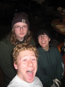 Three people (Owen, middle) pose for a selfie