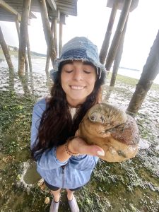 Kate Robertson poses with a large shell