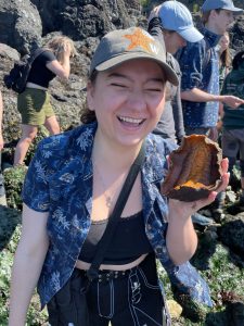 Kaiya holds up a sea organism