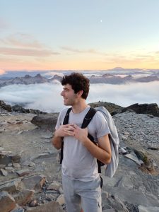 Dylan Strauss at the top of a mountain when hiking