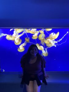 Alexias Thao stands in an aquarium