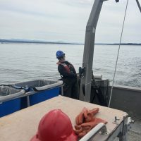 Megan Cosand stands on a boat.