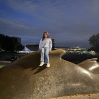 Student sitting on humpback statue