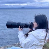Student with long lens camera