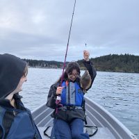 Woman fishing on boat