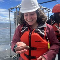 Holding a sea cucumber aboard a research cruise for class.