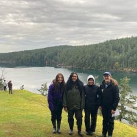group in field in front of water