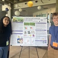 two people in front of poster