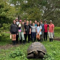Group of people with giant tortoise