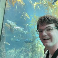Amer_Gavin_in front of aquarium tank