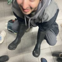Man with wading boots on arms