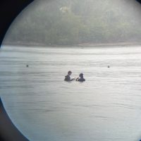 photo of 2 people diving through lense