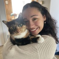 woman holding calico cat