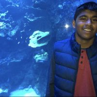 Rishab in front of aquarium